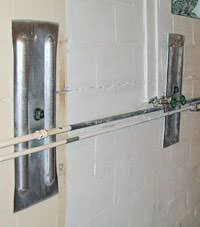 A foundation wall anchor system used to repair a basement wall in Louisa