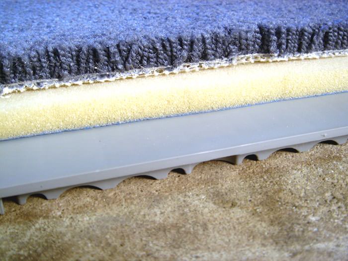 Insulated Suloor Installation Saint Albans Basement Floor Decking A Closeup View Of Our Sub Floor Matting With Basement Carpet Installed On Top